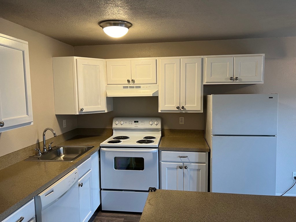 a kitchen with white appliances and white cabinets