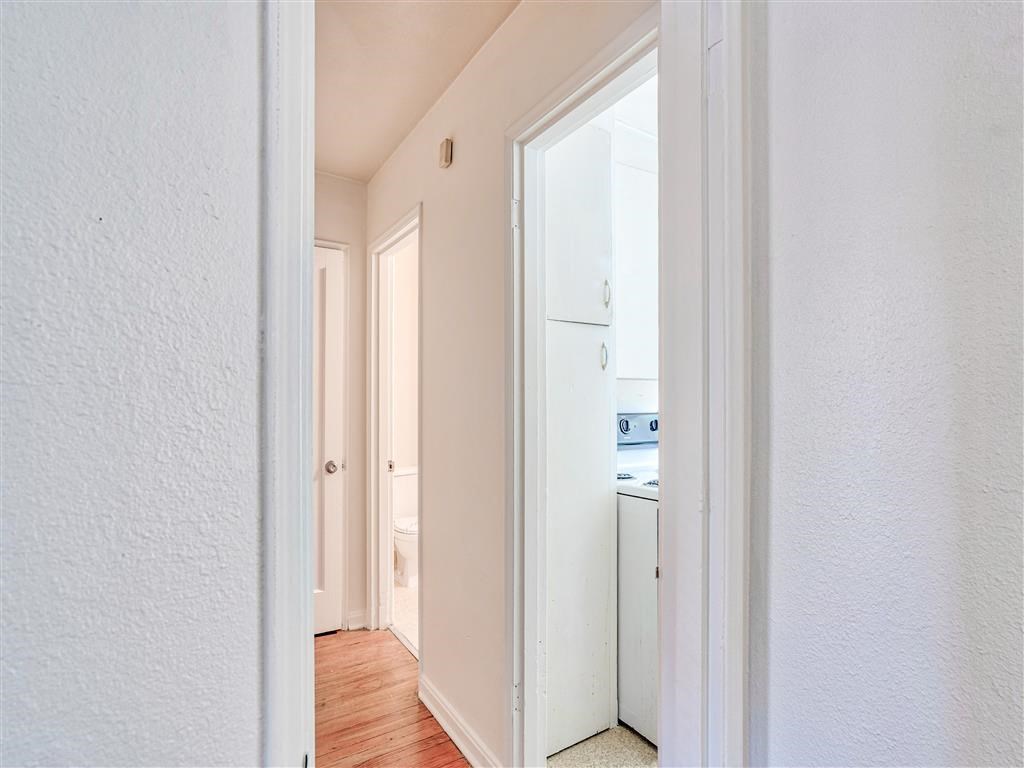 a bedroom with a door to a bathroom and a closet