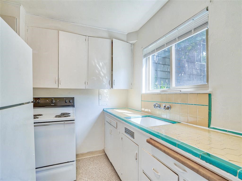 a kitchen with white appliances and white cabinets