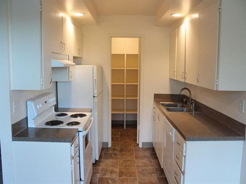 a kitchen with white appliances and white cabinets