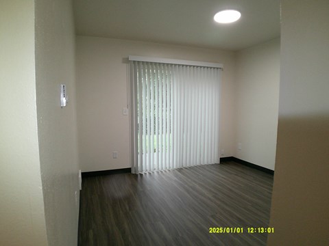 A room with a sliding door and a window with blinds.
