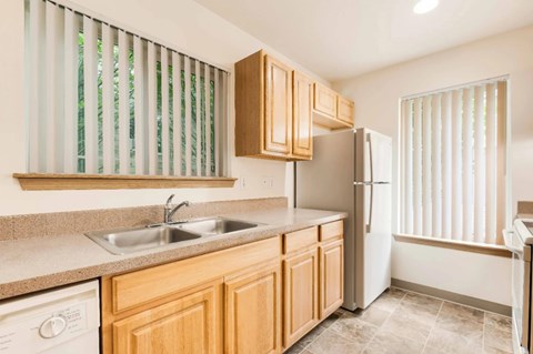 A kitchen with wooden cabinets and a white refrigerator.