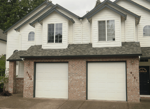 A two-car garage is attached to a house.