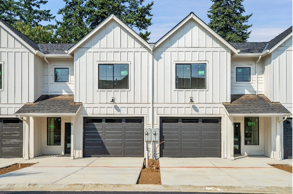 a white house with two garage doors