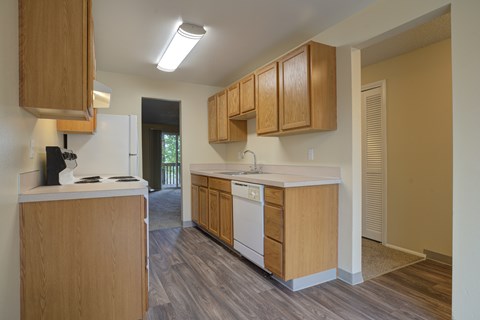 A kitchen with wooden cabinets and a white countertop.