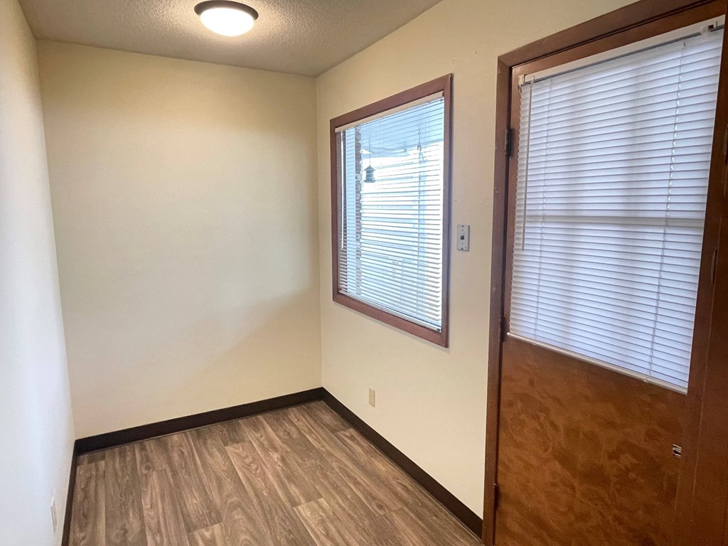 an empty room with a window and a door