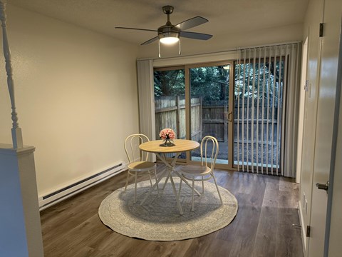 A dining room with a round table and chairs.