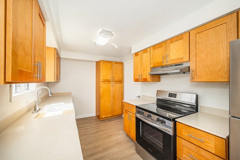 A kitchen with wooden cabinets and stainless steel appliances.