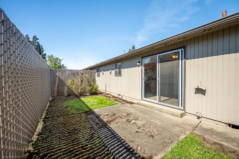 A metal fence runs along the side of a building.