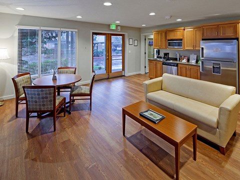 A kitchen with a dining table and chairs.