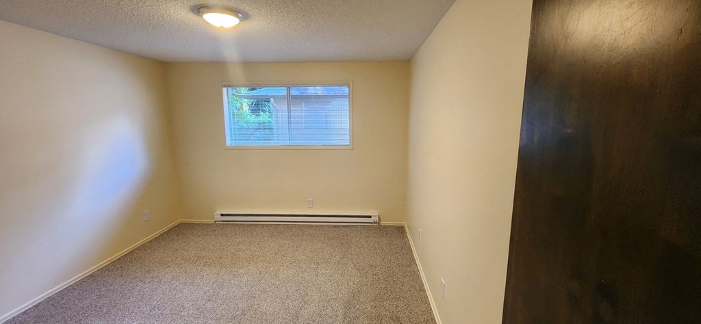 Nell Anna Court room with a window and a carpeted floor.