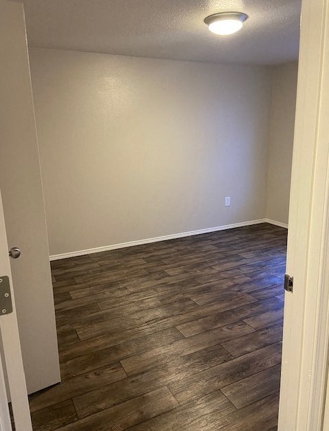 A room with a wooden floor and a white door.