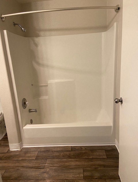 A white bathroom with a walk in shower.
