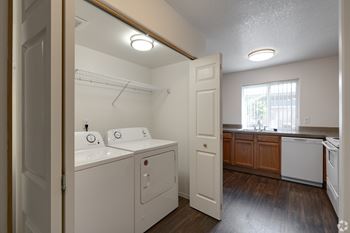 A small laundry room with a washer and dryer.