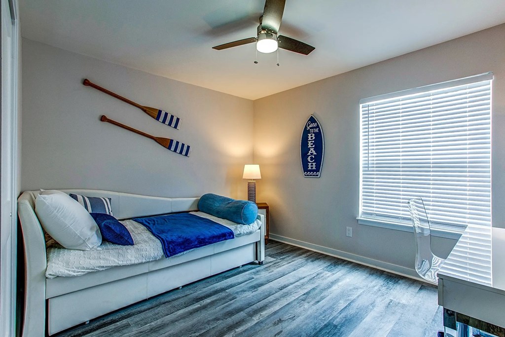 a bedroom with a bed and a ceiling fan