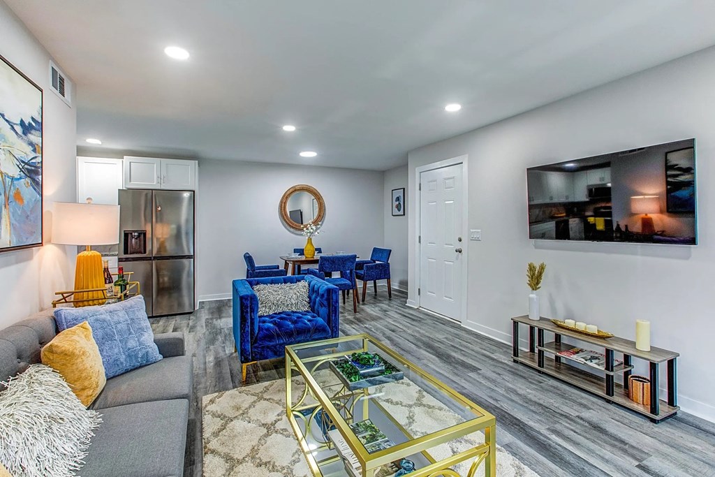 a living room with a couch and chairs and a table