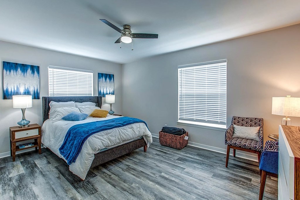 a bedroom with a bed and a ceiling fan