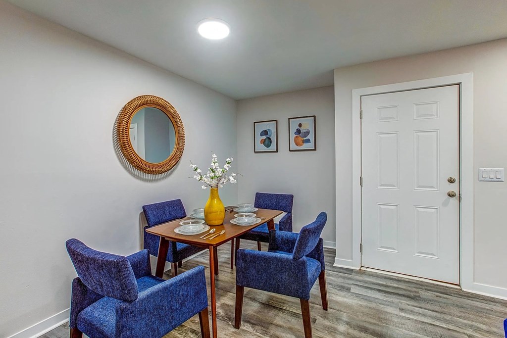 a dining room with blue chairs and a table