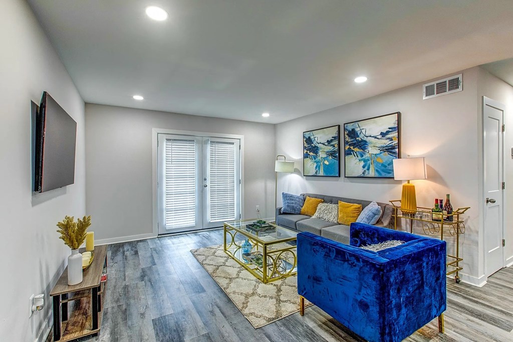 a living room with a blue couch and a tv