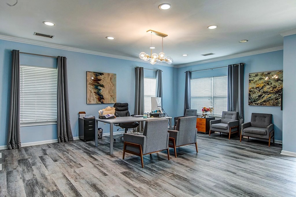 a dining room with blue walls and a table and chairs