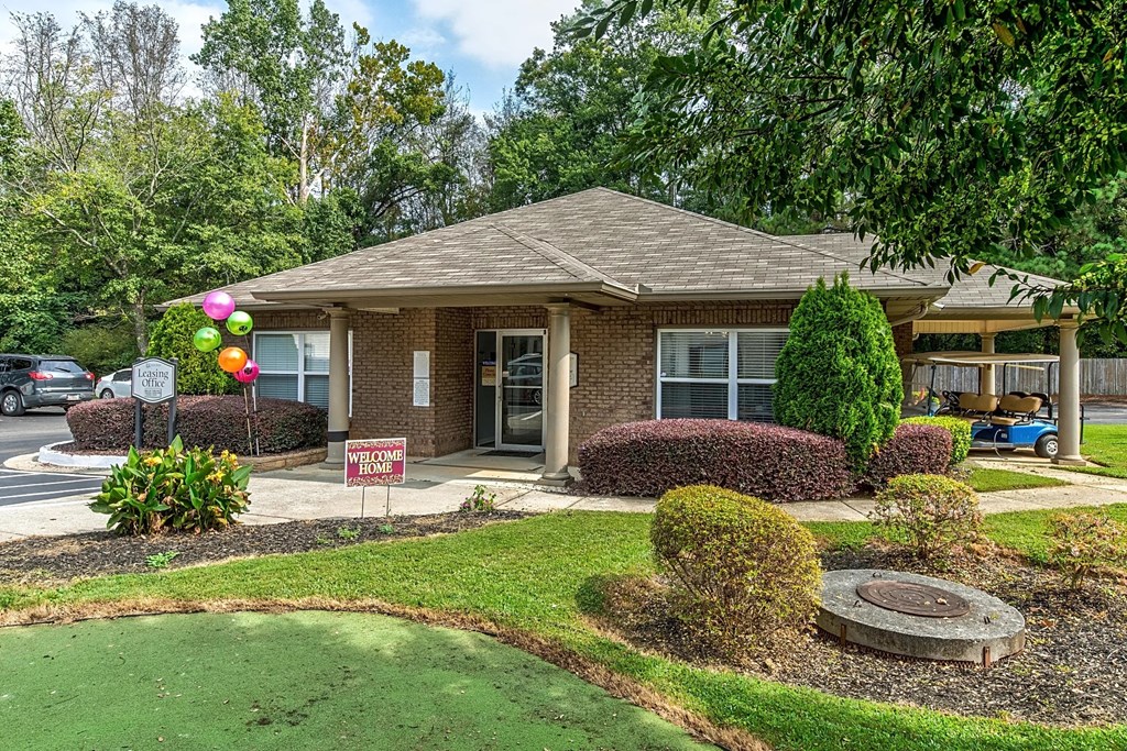 a house with a yard and a sign in front of it