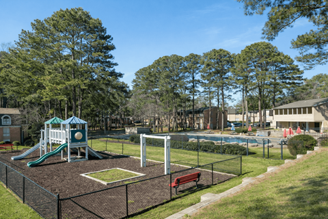 A playground with a slide, swings, and a basketball hoop.
