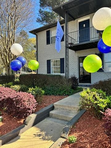 a house with a bunch of balloons in front of it