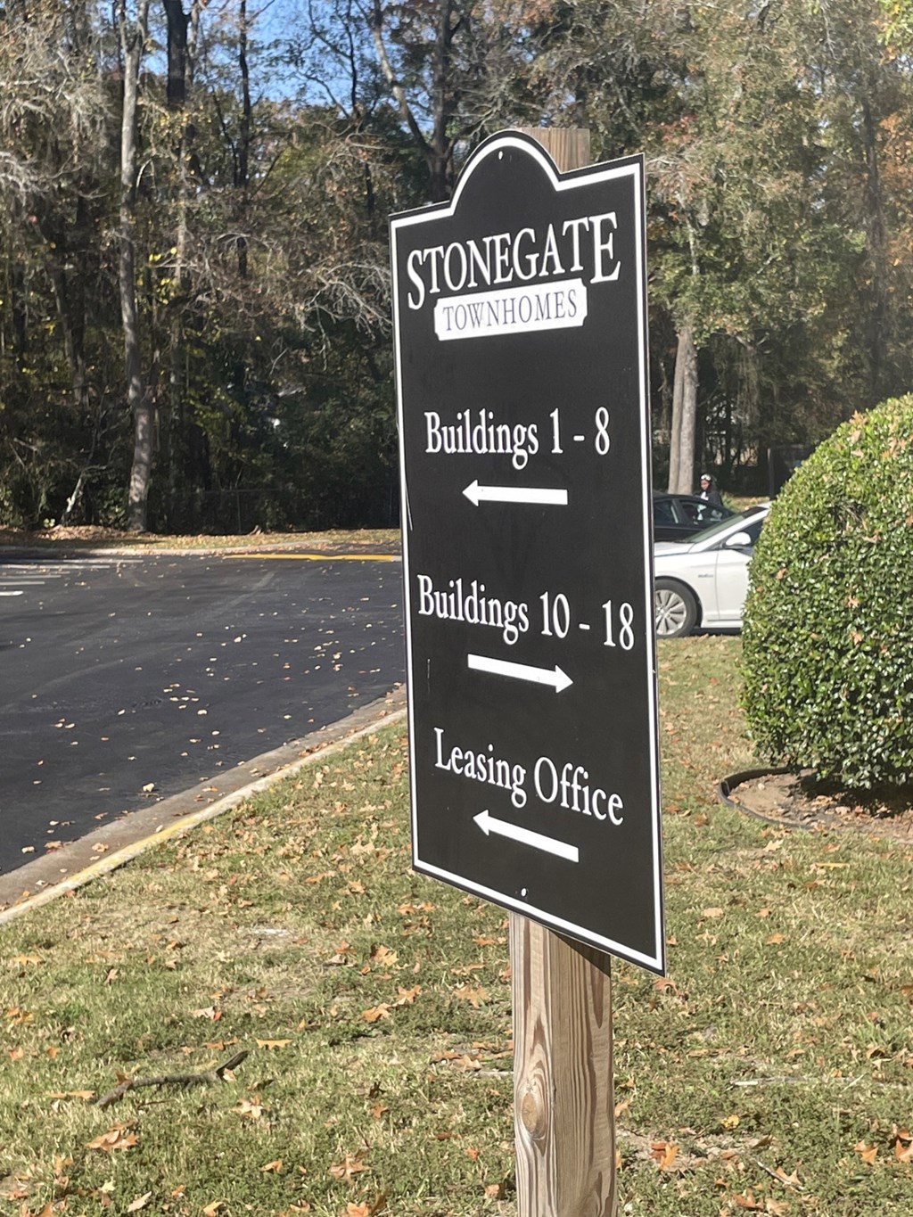 a sign in front of a road that says stonegate condos buildings 1 8 buildings 10 18