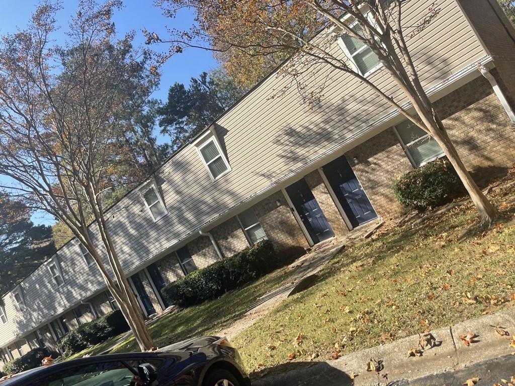 a building on a hill with a car parked in front of it