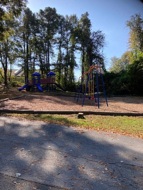 a playground in a park with trees in the background