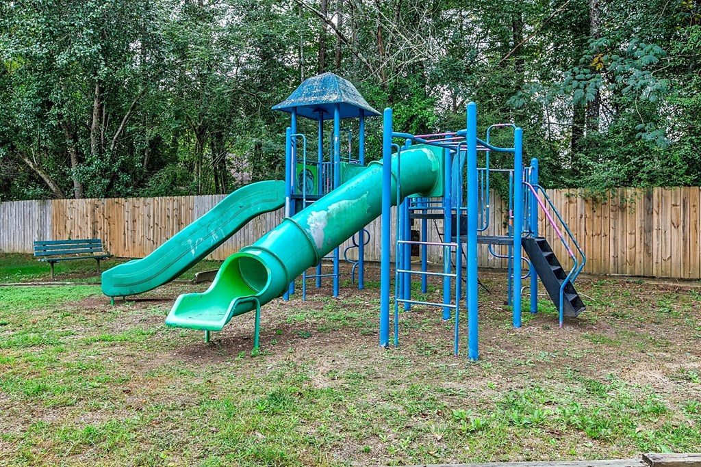 a playground with a slide and a tube