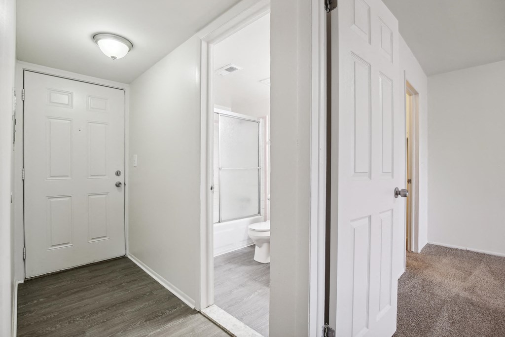A white door is open to a bathroom.