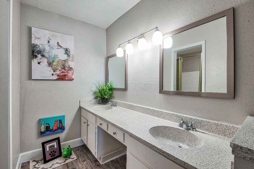 A bathroom with a sink, mirror, and lights.