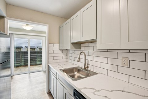 A kitchen with a sink and cabinets.