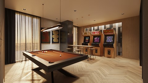 A pool table is in the middle of a room with a row of arcade machines.