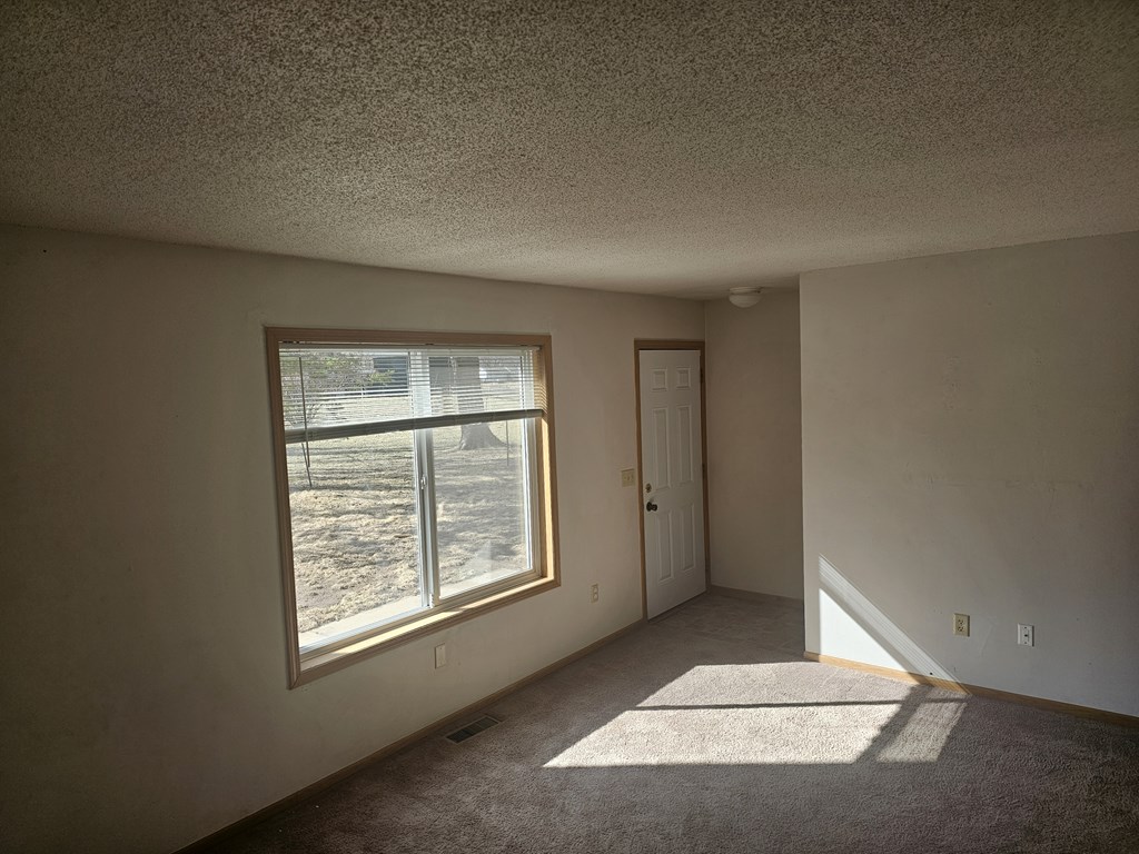 A room with a window and a door.