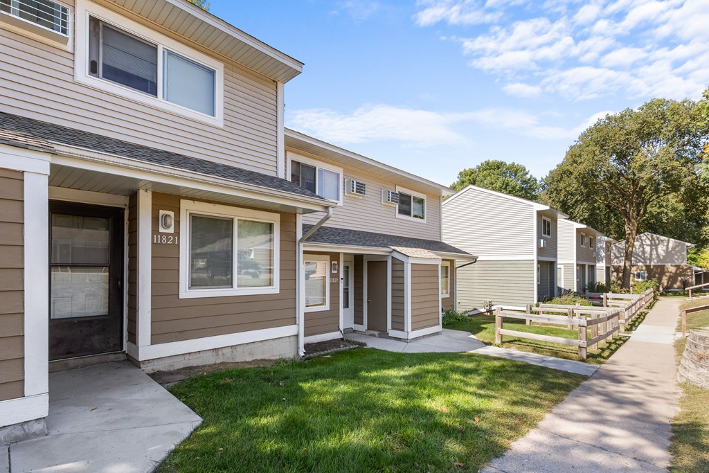 A row of houses with a clear blue sky above them.