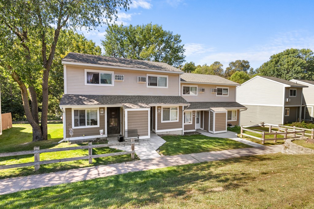 A house with a white picket fence in front.