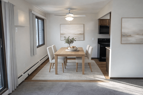 A dining room with a table set for four.