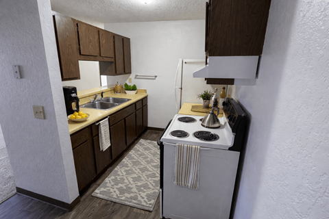 A small kitchen with a white stove top oven.