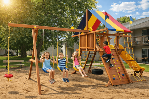 Three children playing on a swing set in a sandy area.