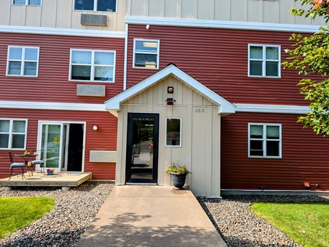 A red building with a black door and windows.