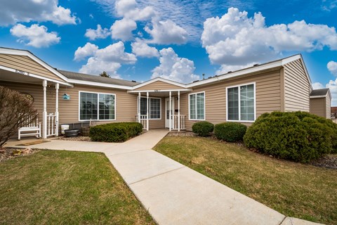 A residential building with a driveway in front.