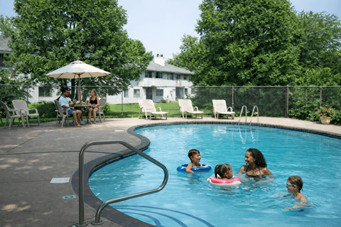 A group of people are enjoying a swim in a pool.
