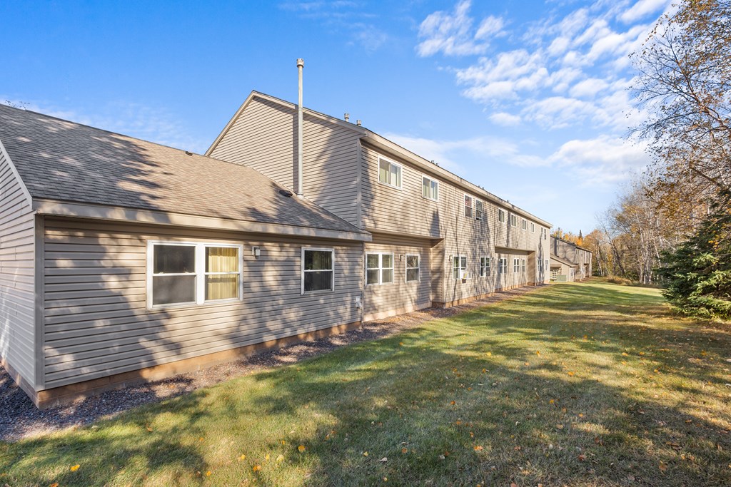A long building with a grey roof and a cross on top.