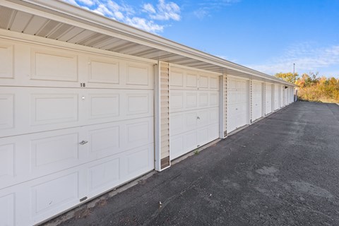 A long row of white garage doors are closed.