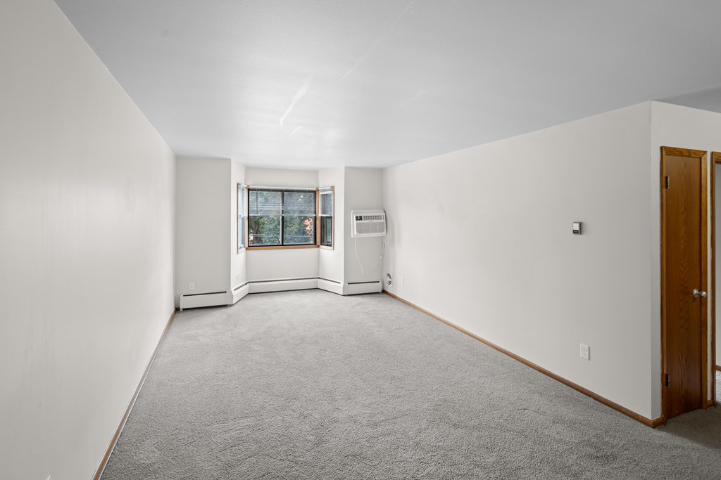 A room with a window and a door.