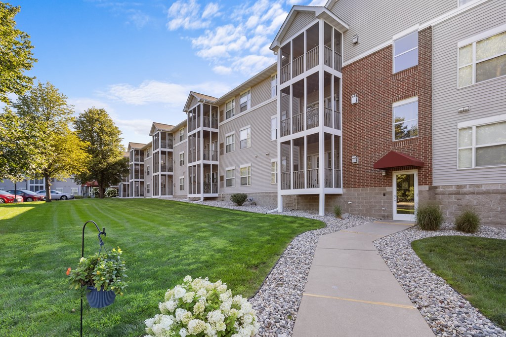 A building with a red awning is at the end of a walkway.