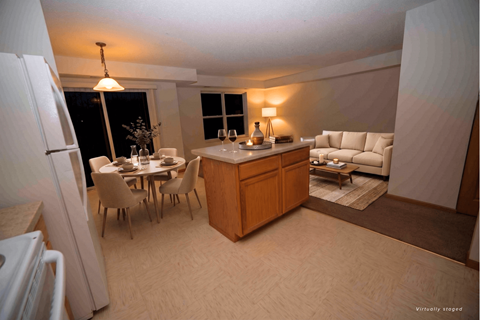 A kitchen with a table and chairs.