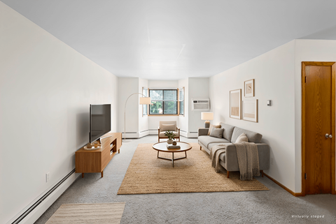 A living room with a grey couch and a wooden coffee table.